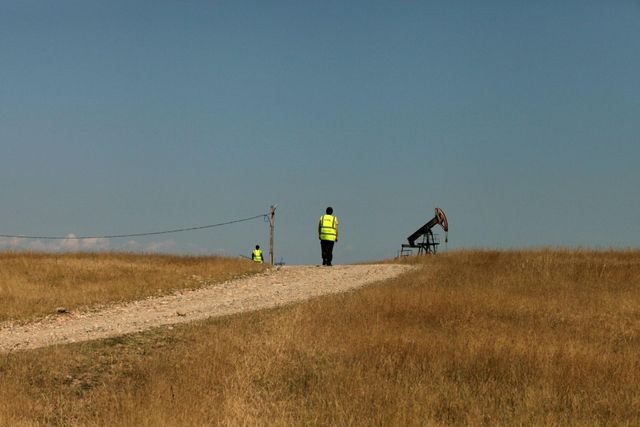 Inspecting extraction infrastructure along an unpaved rural road. Photo courtesy of the artist