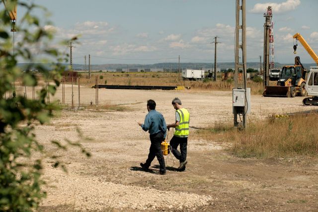 Researchers scanning the industrial site with handheld methane detection equipment. Photo courtesy of the artist