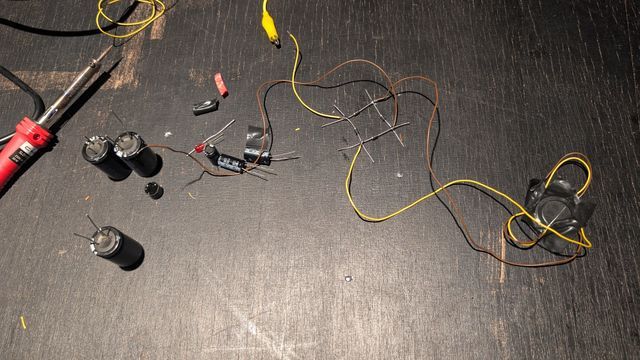 Completed harvester prototype circuit linking capacitors, rectifiers, and custom wiring